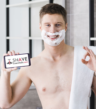 Man with shave cream going to ShaveEssentials.com on his phone
