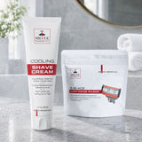Shave Essentials Cooling Shave Cream tube standing next to a Shave Essentials 3-Blade Cartridge Razor pouch on a bathroom counter.