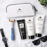 Shave essentials set with razor, cream, and after-shave on a white surface.